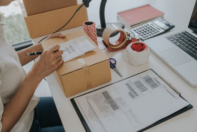 High angle view of woman using laptop on table