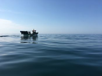 Man in boat on sea against sky