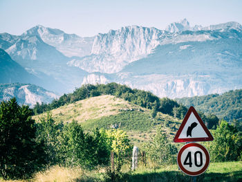 Curve ahead sign entering a mountain region