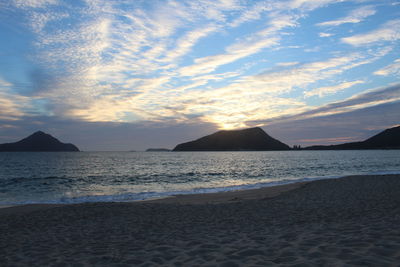 View of seascape against cloudy sky