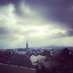 Cityscape against cloudy sky