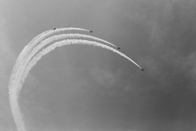 Low angle view of airplane flying against sky