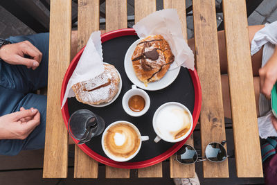 Baked food and coffee on table in cafe