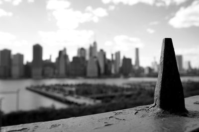 Close-up of buildings in city against cloudy sky