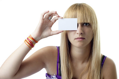 Portrait of young woman using smart phone against white background