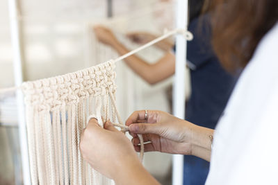 Midsection of woman holding ropes