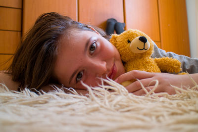 Close-up of young woman with teddy bear