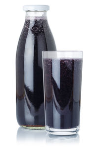 Close-up of glass bottle against white background