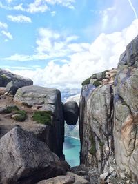 Scenic view of rock formations against cloudy sky