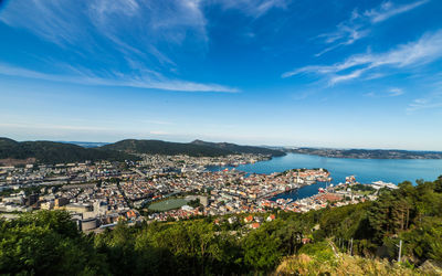 High angle view of townscape by sea against sky