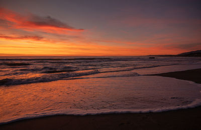 Scenic view of beach against sky during sunset