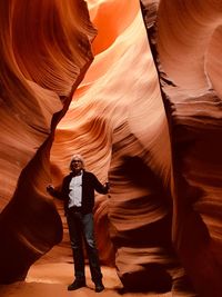 Portrait of man standing by rocks