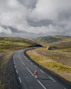 Man on road against sky