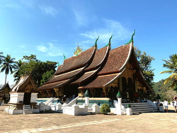 Traditional building by trees against sky