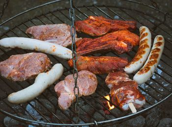 High angle view of meat on barbecue grill