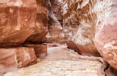 The siq, the narrow slot-canyon that serves as the entrance passage to hidden city of petra, jordan,