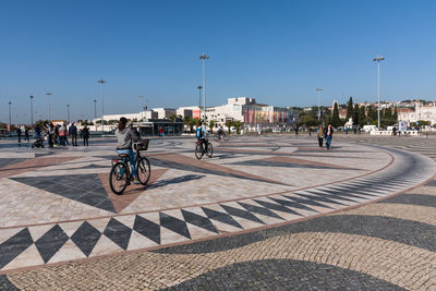 People on street in city against clear sky