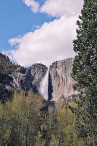 Panoramic view of landscape against sky with a waterfall