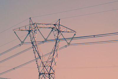 Low angle view of electricity pylon against sky