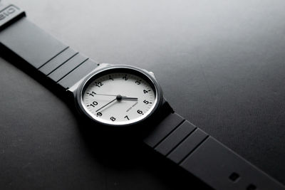 High angle view of wristwatch on black background