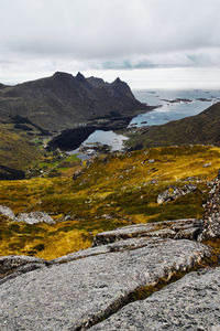 Scenic view of village at the sea and mountains against sky on lofoten islands in norway