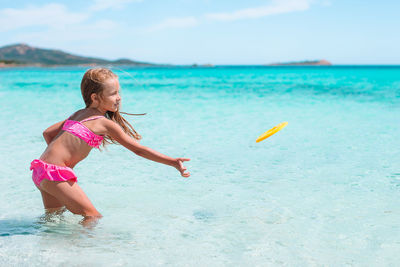 Young woman swimming in sea