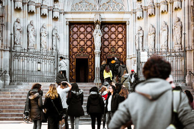 Rear view of people walking outside building