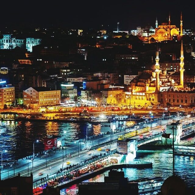 architecture, illuminated, built structure, building exterior, water, city, night, transportation, river, nautical vessel, waterfront, mode of transport, reflection, cityscape, boat, bridge - man made structure, city life, high angle view, moored, connection