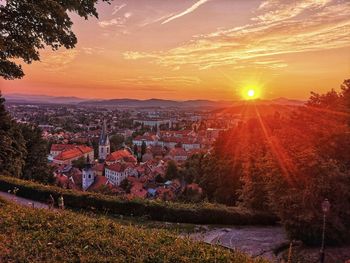 Aerial view of townscape against sky at sunset