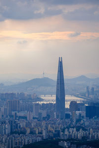 Buildings in city against sky during sunset
