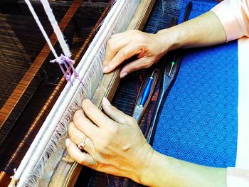Close-up of person hand working at textile industry
