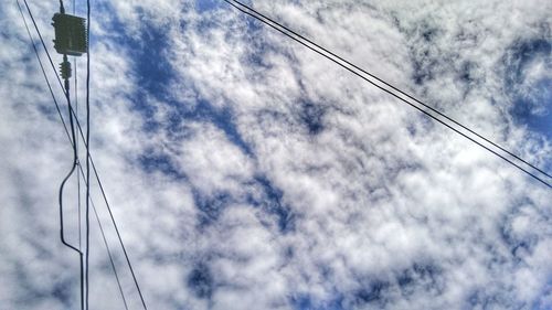 Low angle view of electricity pylon against sky