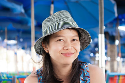 Portrait of smiling young woman wearing hat