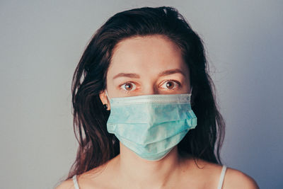 Close-up portrait of woman wearing mask