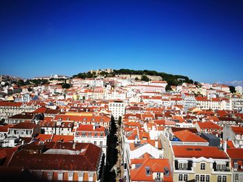 Aerial view of townscape against clear blue sky