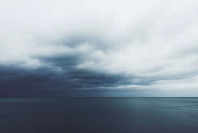 Scenic view of sea against cloudy sky