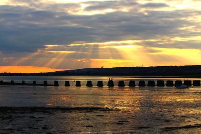 Scenic view of river against sky during sunset