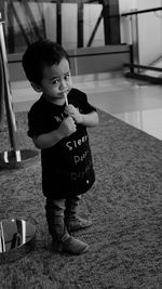 Portrait of cute baby boy standing at home