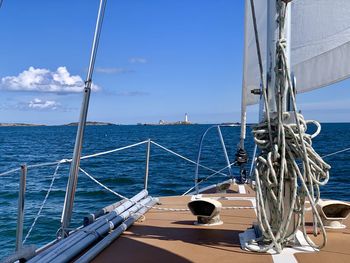 Sailboat sailing on sea against sky