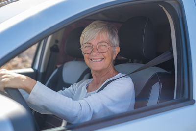 Portrait of senior woman sitting in car