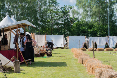 People on field against trees