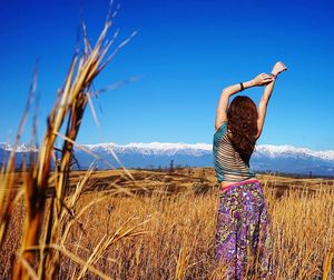 Person standing on field against clear sky