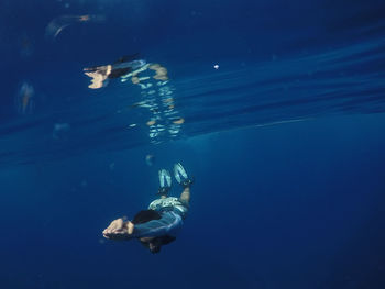 Man swimming in blue sea