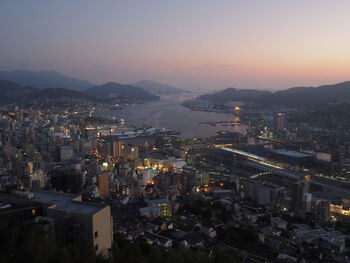 High angle view of illuminated buildings against sky at sunset