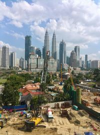 View of cityscape against cloudy sky