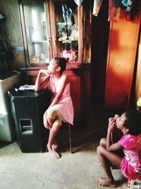 Side view of a girl sitting on floor