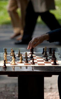 Cropped hand of man playing chess