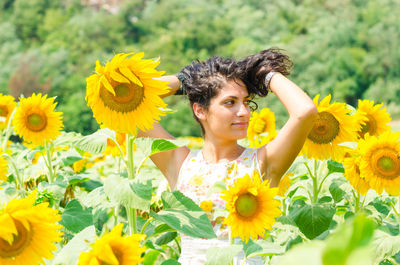 Portrait of smiling woman with sunflower