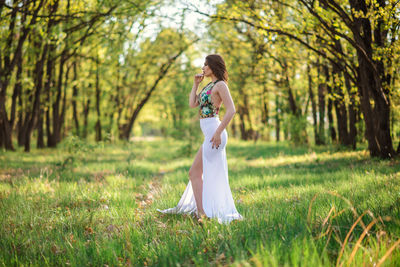 Full length of woman standing on field