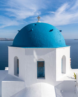 Close up of a typical blue dome church in santorini at oia village, greece